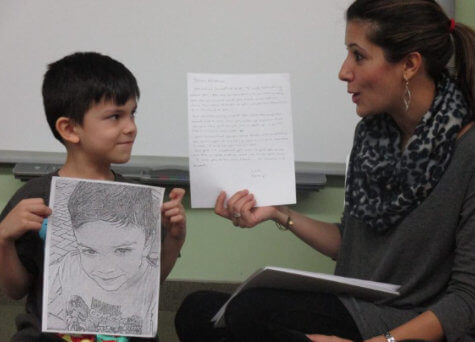 kid showing his drawing