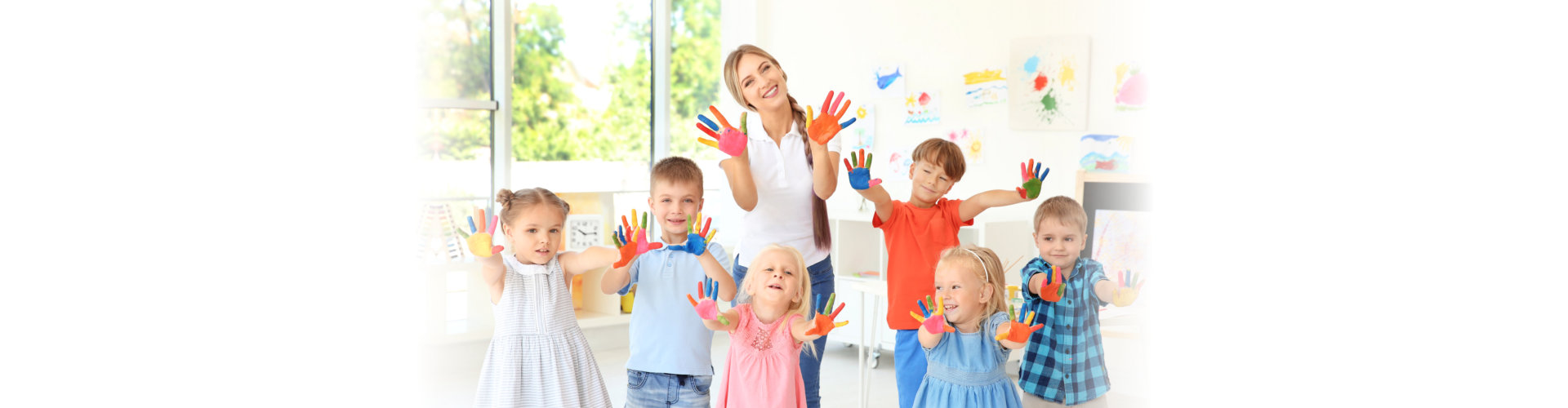 teacher and students waving their hands with paint on it